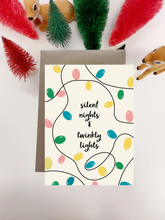 Load image into Gallery viewer, Irish Made Christmas card with colorful lights and text 'silent nights & twinky lights' on a white background.